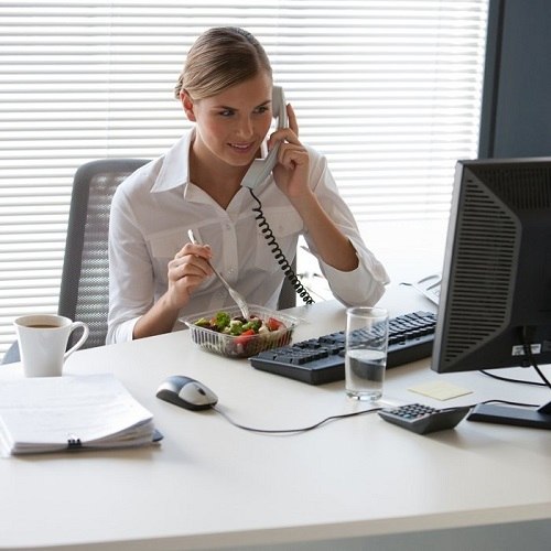 eating at desk Woman eating at her desk.